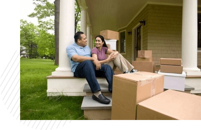 Happy couple with boxes, talking on porch